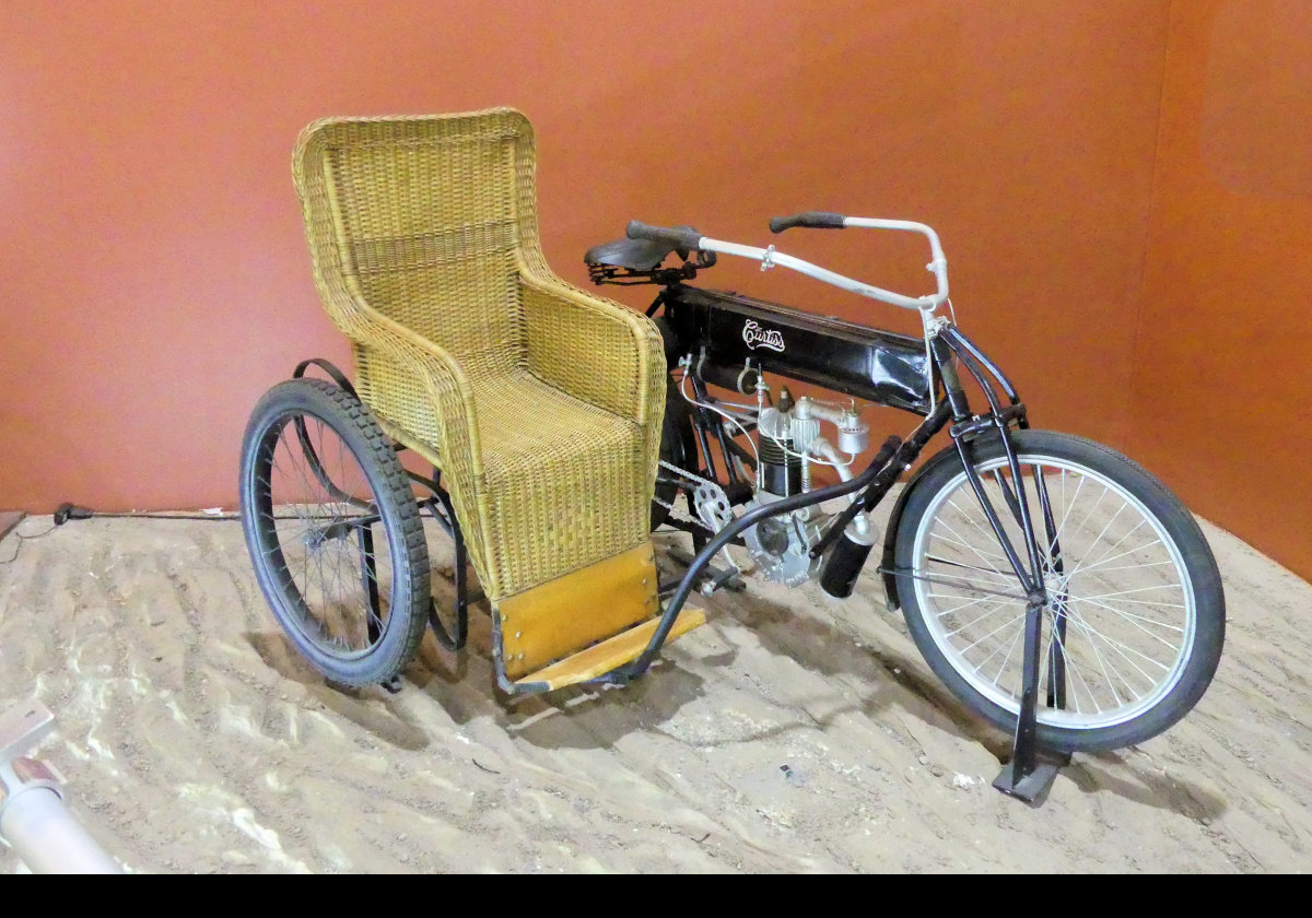 Curtiss V-Twin with Sidecar 1908.  This is a very early version of a motorcycle with sidecar and was indeed a Curtiss accessory. This particular example has a wicker seat and affords no protection in the event of a collision.
